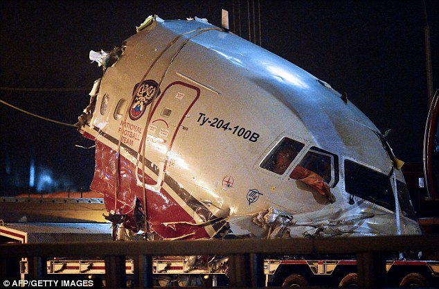 Carnage: A truck removes the cabin of the Tu-204 jet from its crash site near the Vnukovo airport outside Moscow