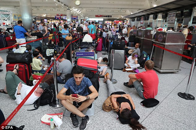 Passengers wait after their flights were cancelled on Saturday at Ataturk International Airport in Istanbul, Turkey following a failed coup attempt