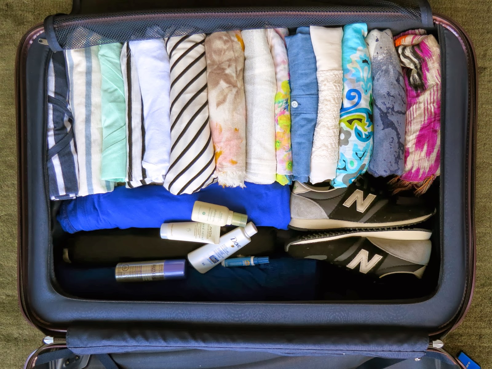 stacked clothes in a suitcase